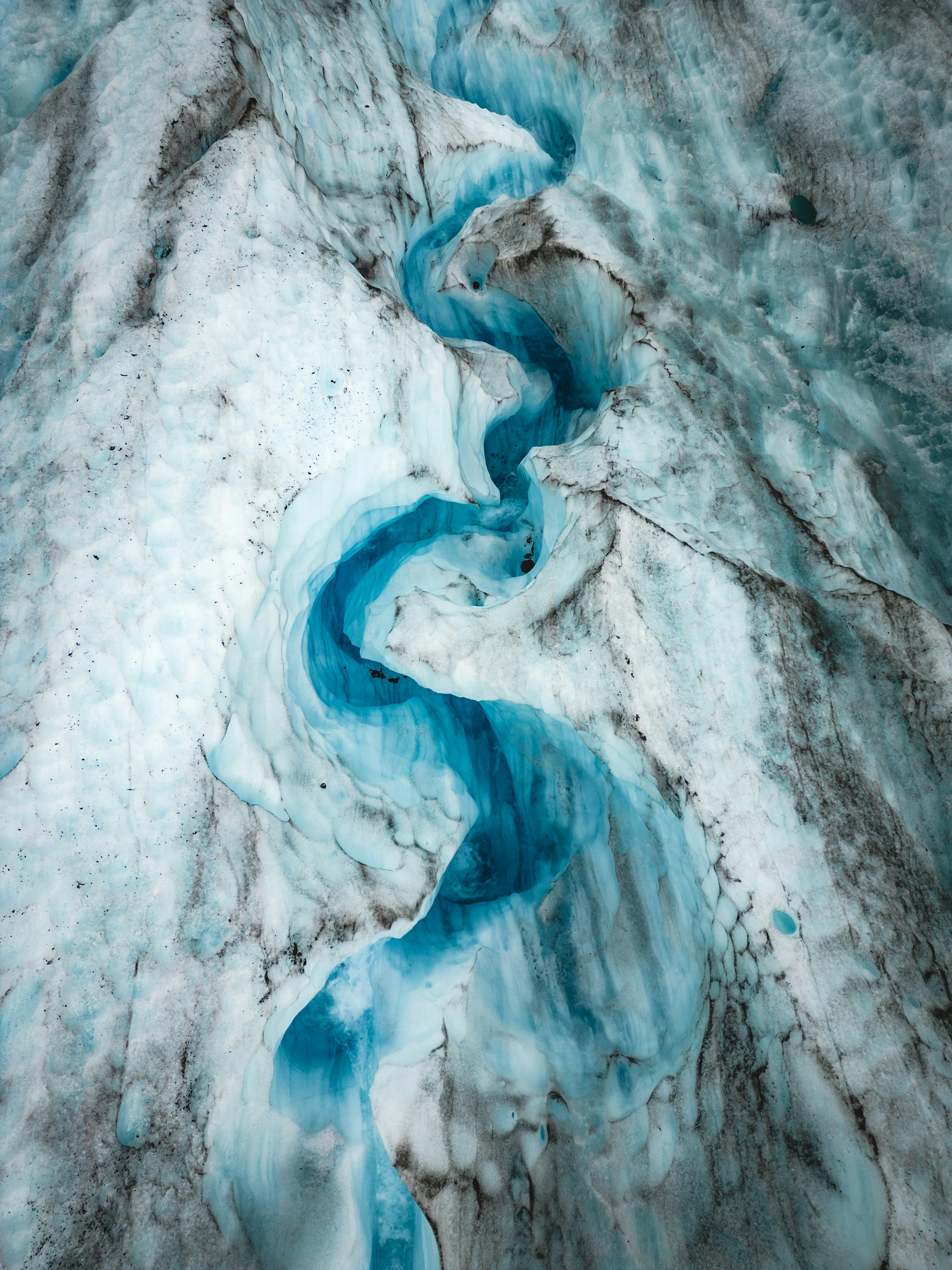 A blue river flowing through glacial ice